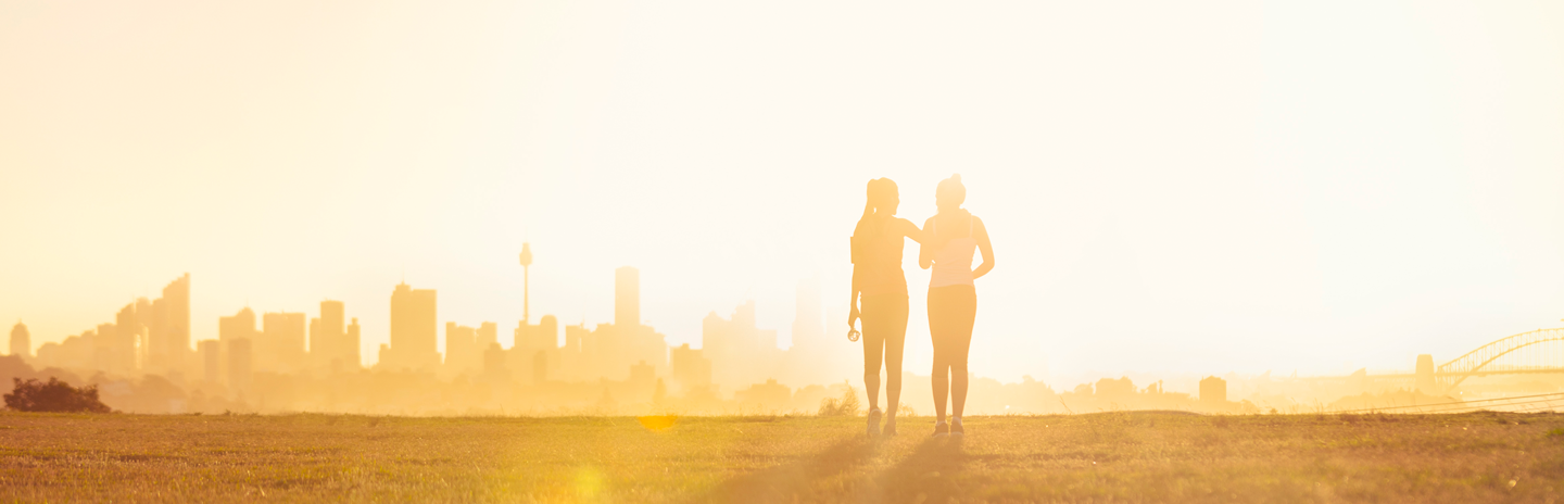Silhouette of 2 women walking in the park