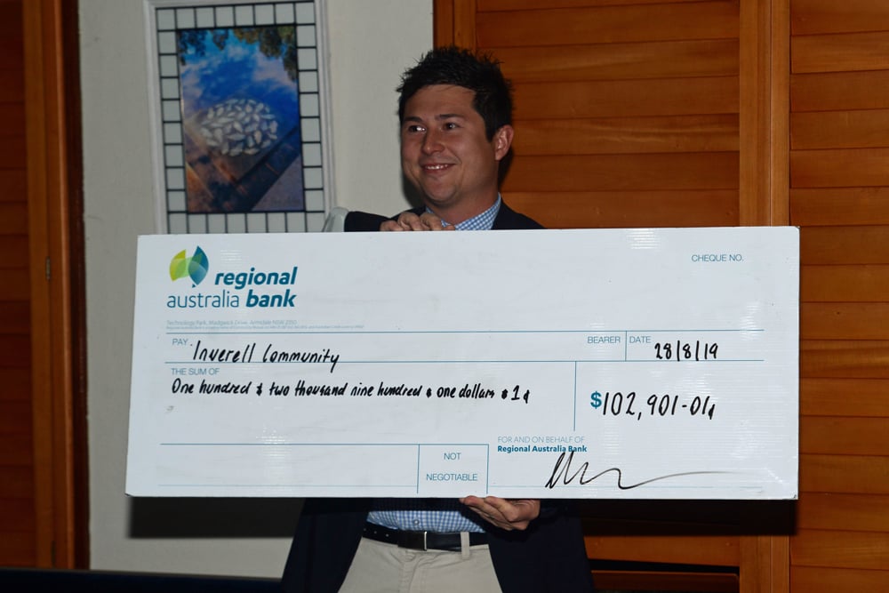 Man holding large cheque for donnation