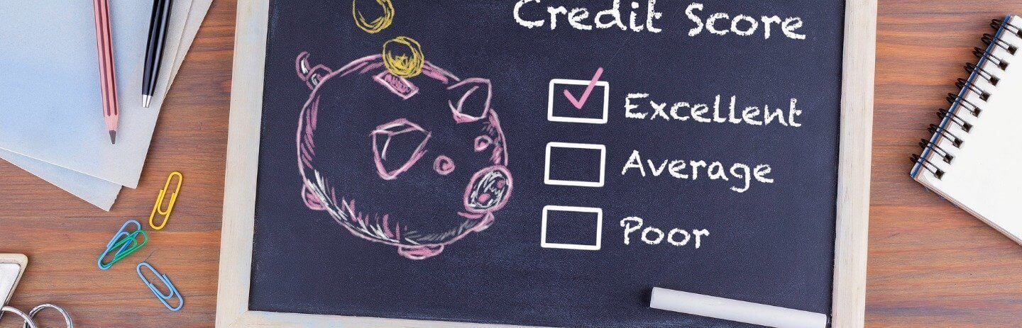 A chalk board drawing of a piggy bank and credit score rating of excellent